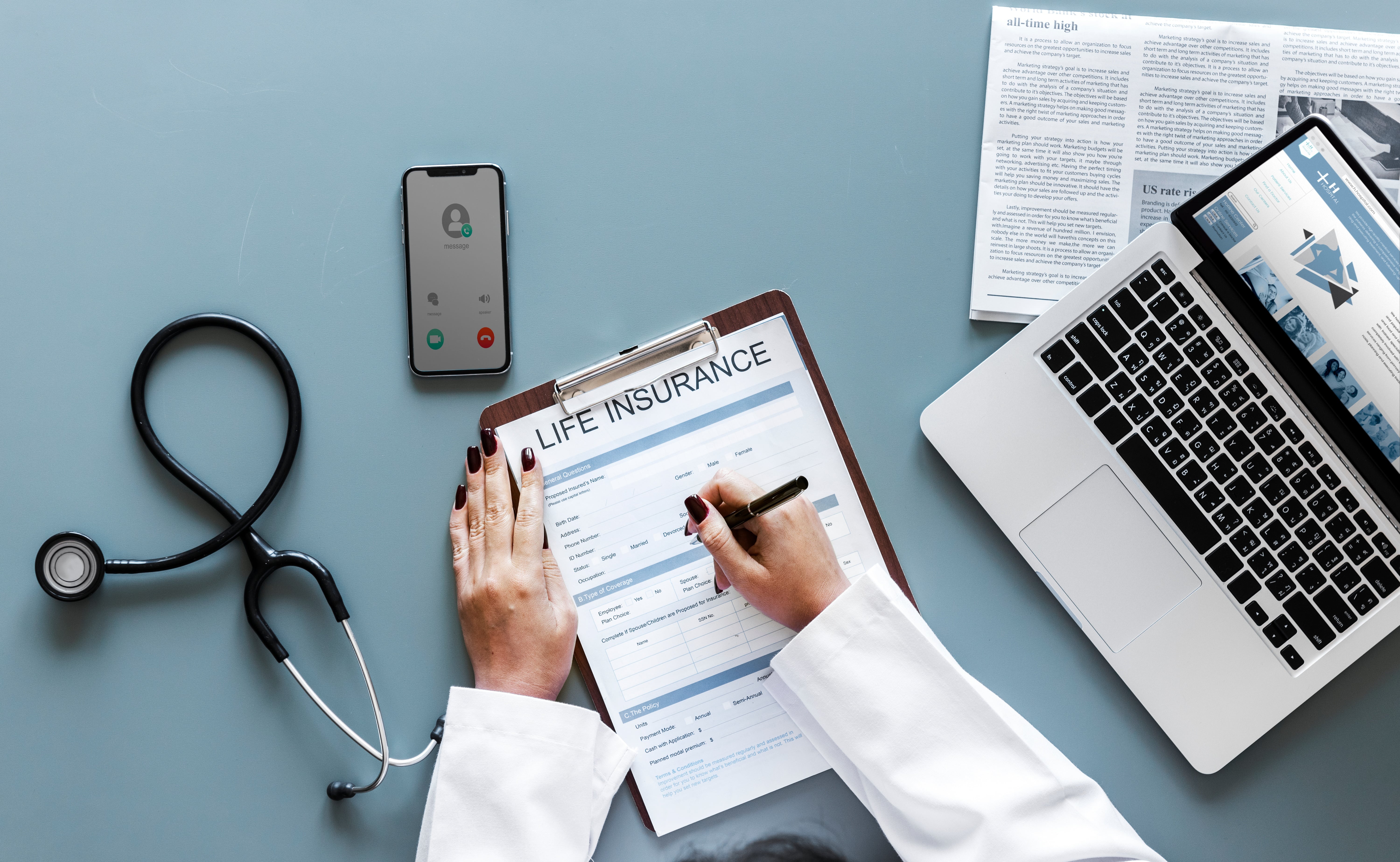 Physician filling out a form.