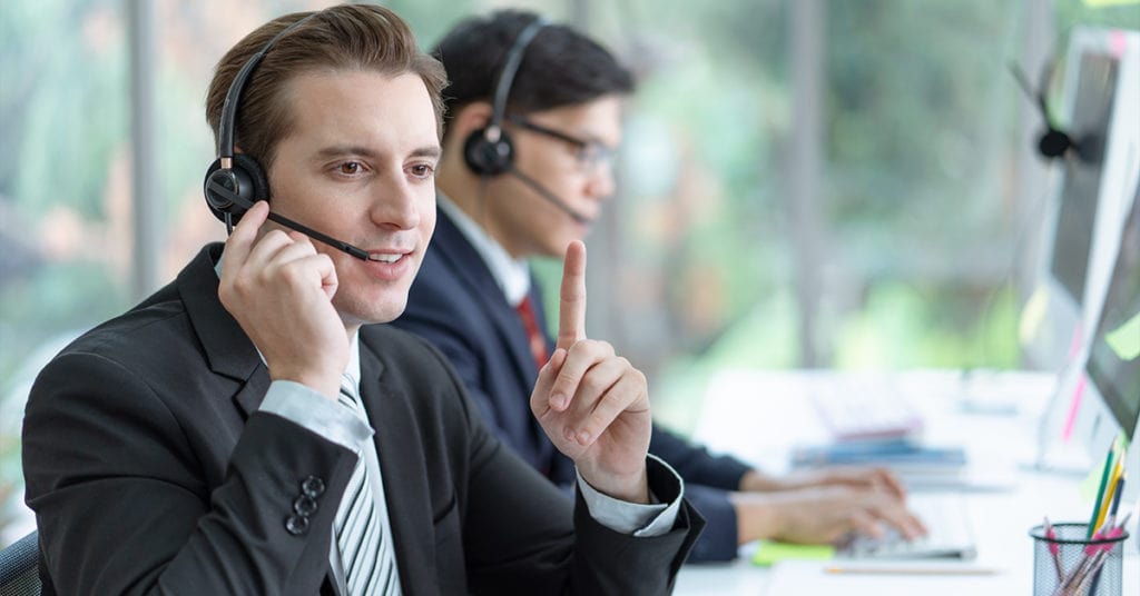 Call center rep talking to a patient on the phone.