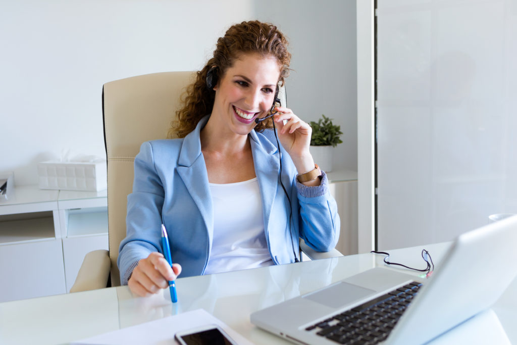 Portrait of customer service operator talking on phone in the office.