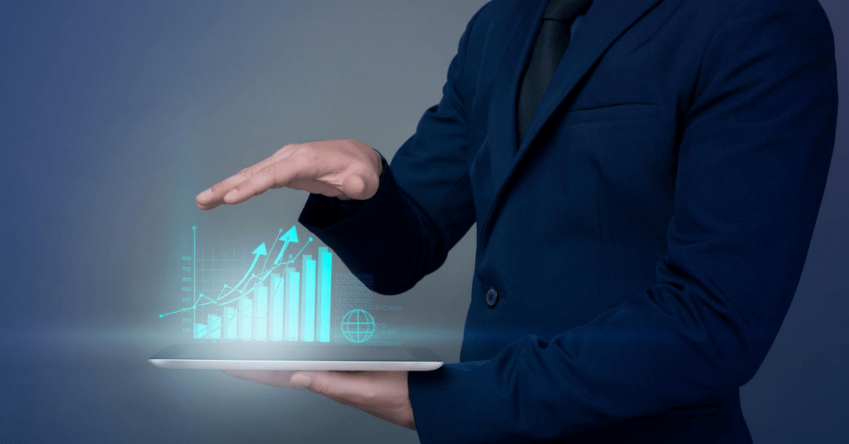 Business man holding tablet showing increase in sales using machine learning.