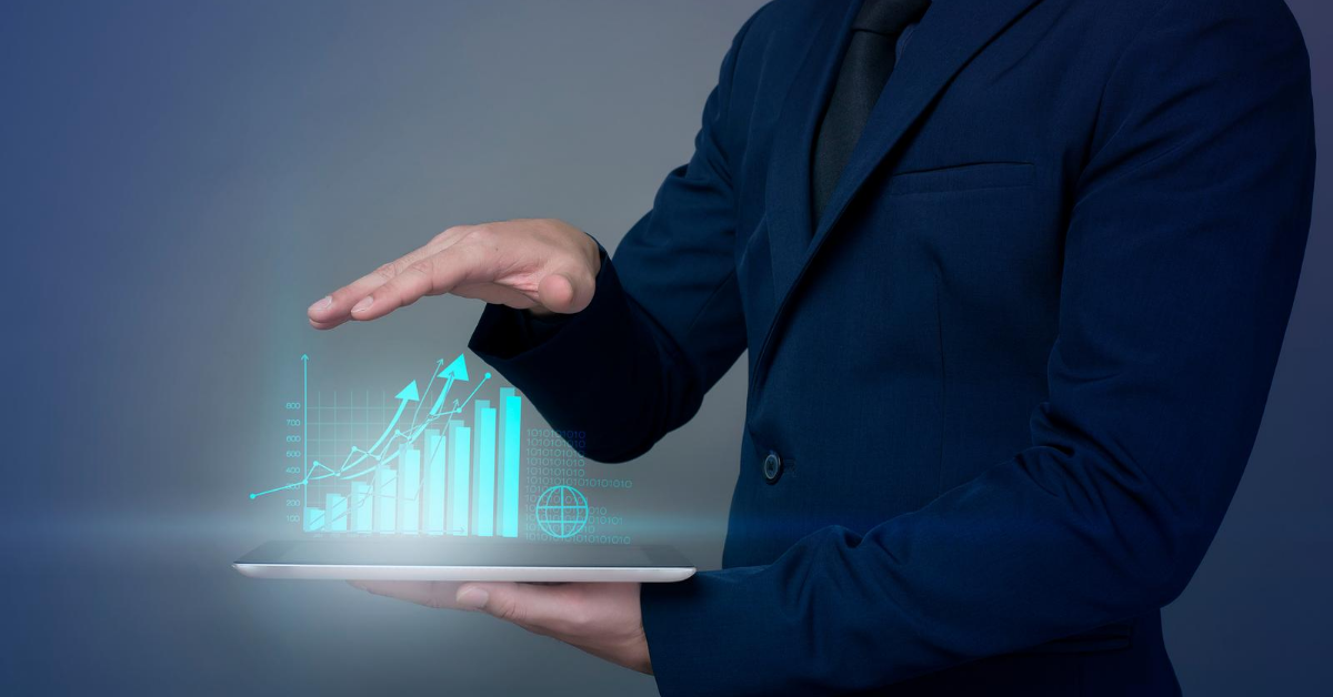 Business man holding tablet showing increase in sales using machine learning.