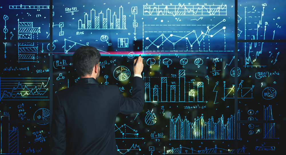 Businessman drawing business statistics on glass wall-2