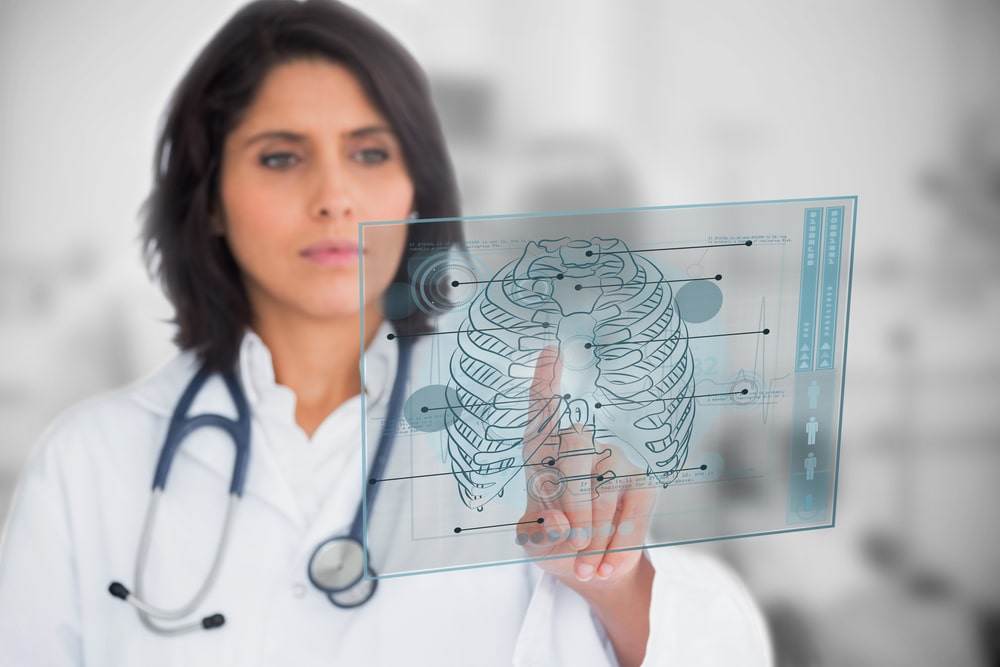 Woman looking at a medical interface in the hospital