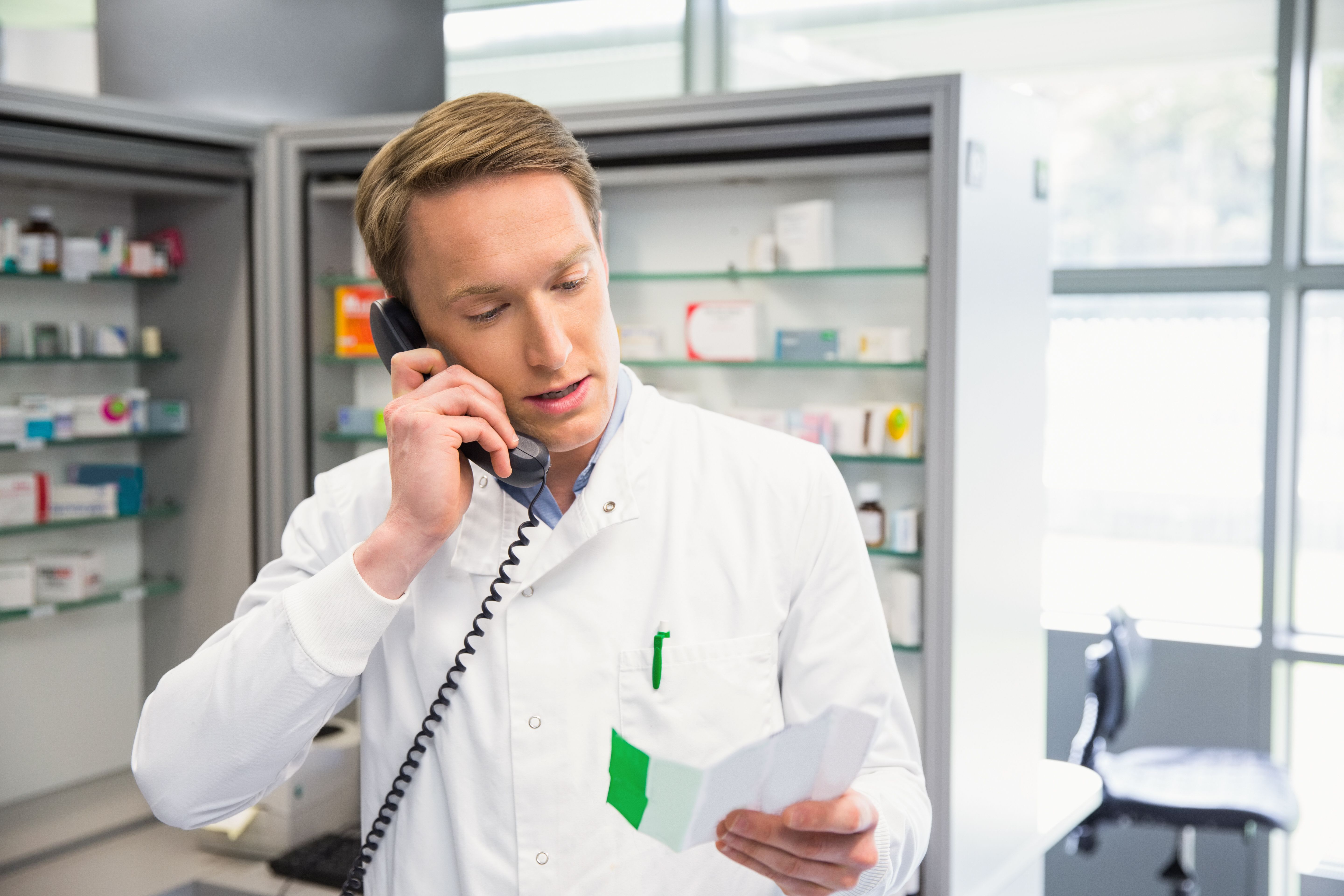 [Happy pharmacist on phone