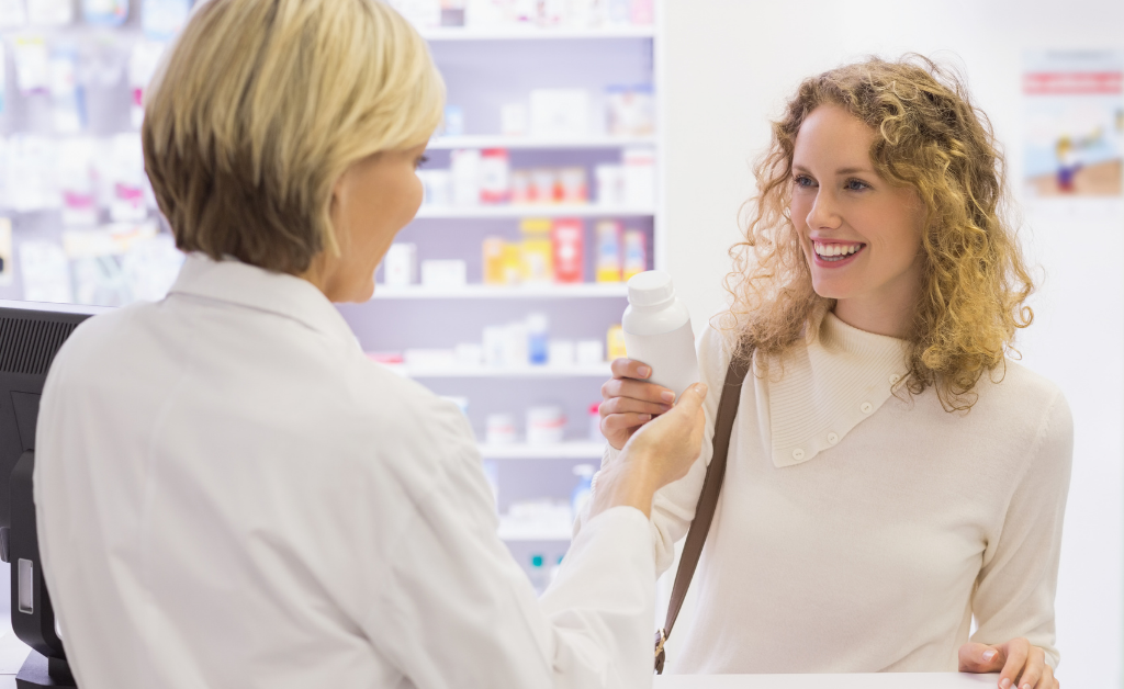 [pharmacist and customer discussing a product in the pharmacy